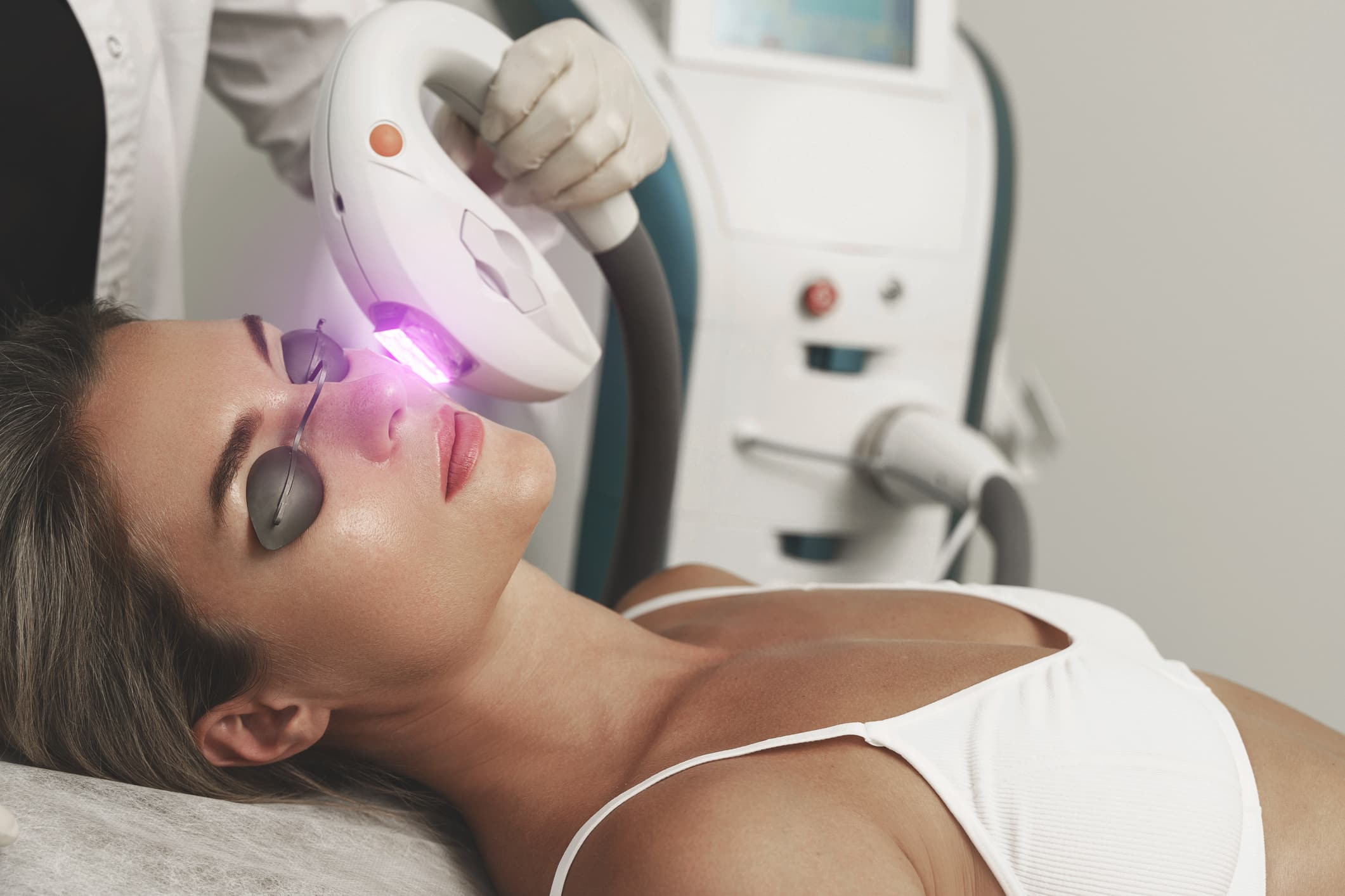 Woman client during IPL treatment in a cosmetology clinic