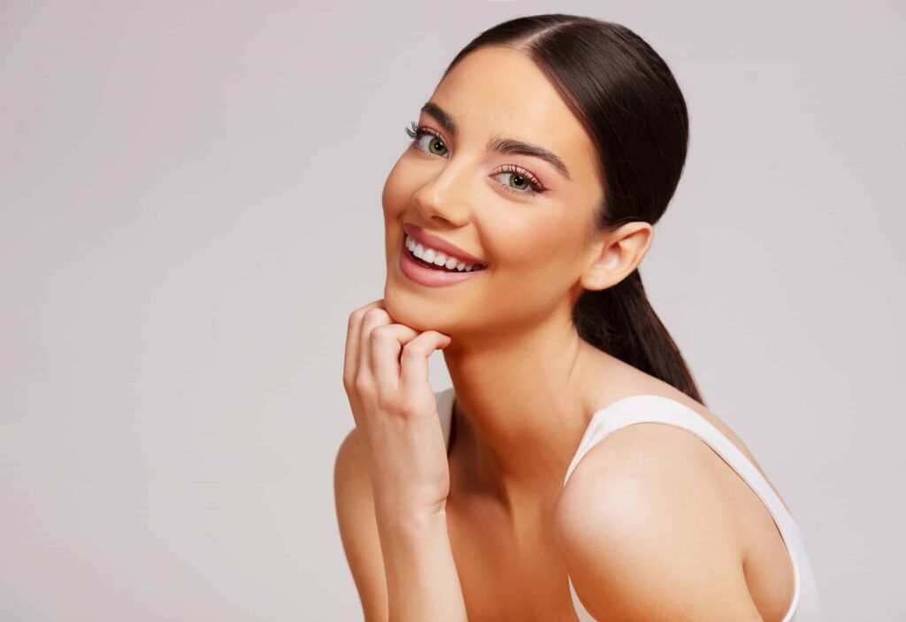 Woman smiling with clear, healthy skin after microneedling in Ashburn, VA