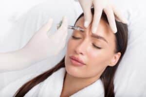 Relaxed woman getting BOTOX injections in forehead in Ashburn, VA