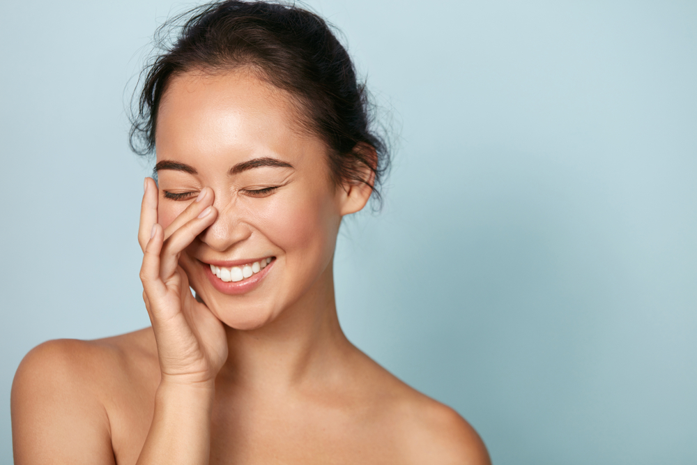 Woman smiling with clear skin after dermaplaning or microdermabrasion
