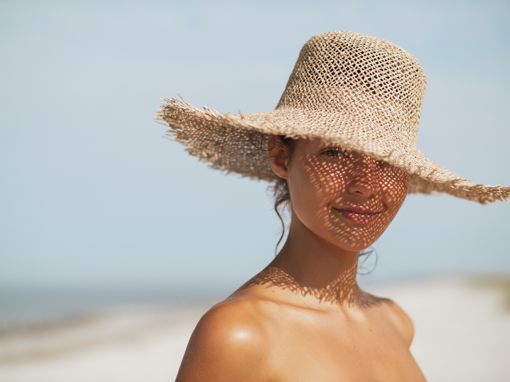 Woman wearing a hat in the summer to protect her skin, Ashburn, VA